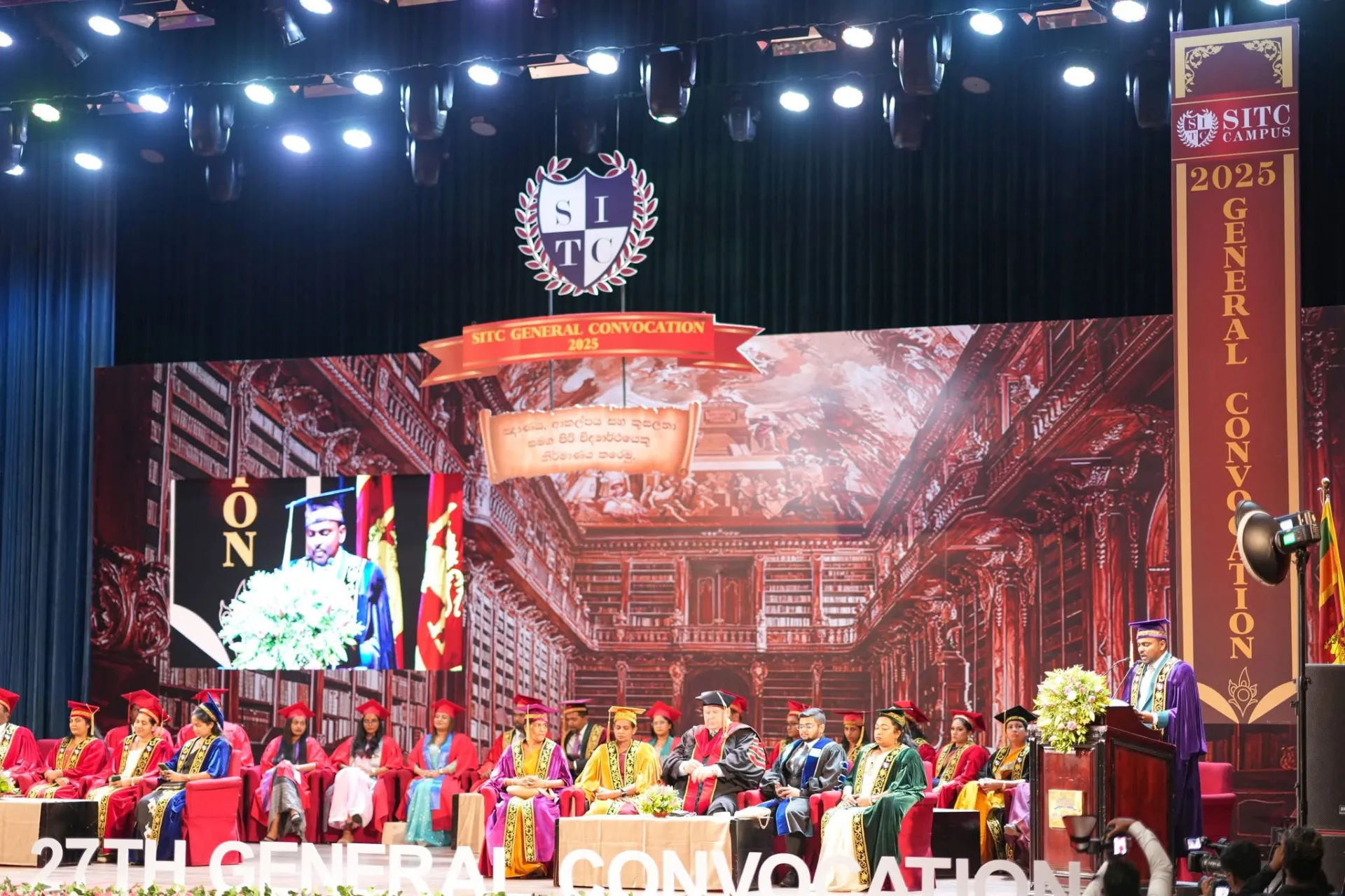 Large convocation stage with lighting and live screen production