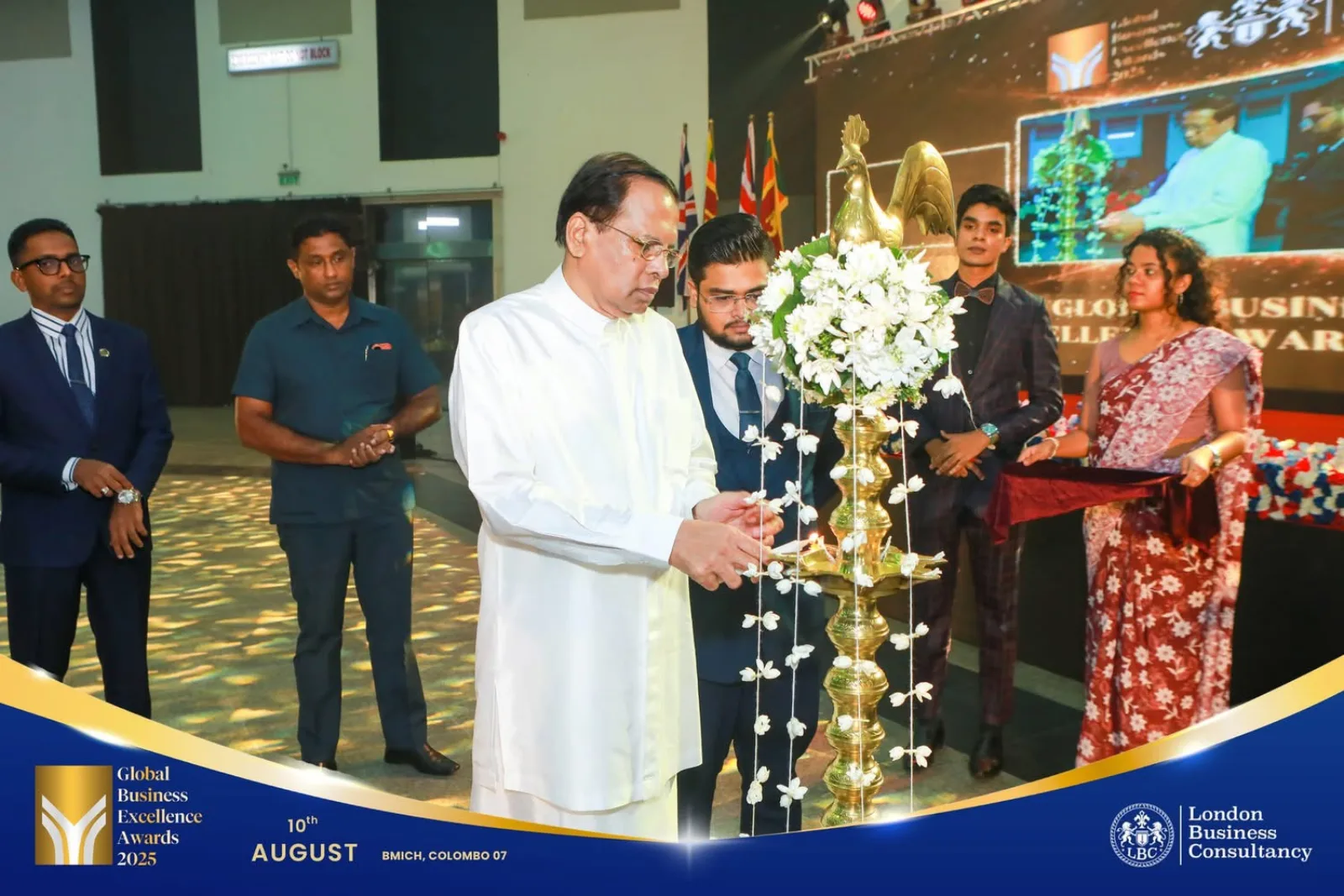 Traditional oil lamp lighting at a formal awards event in Colombo