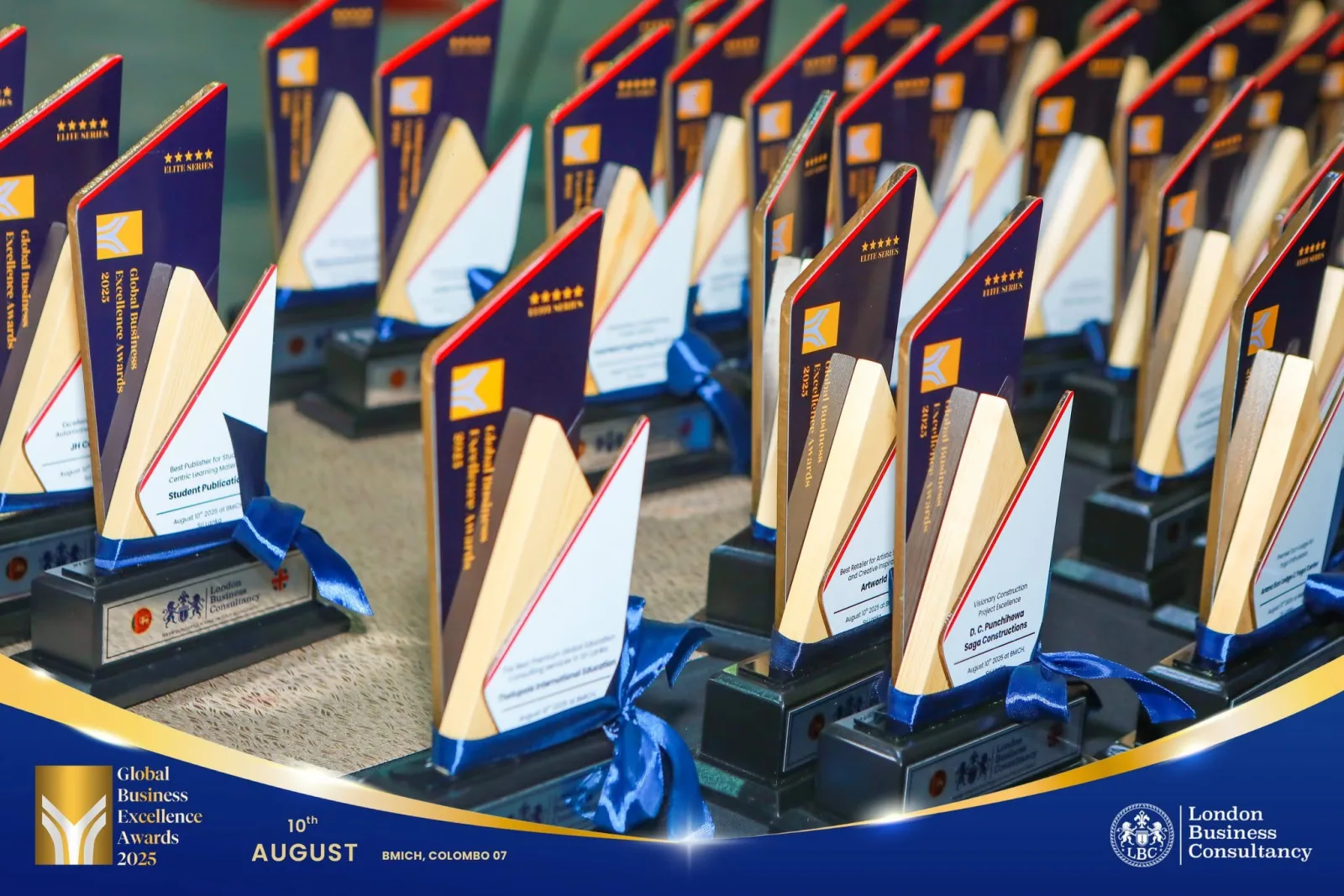 Rows of custom trophies prepared for a business awards ceremony