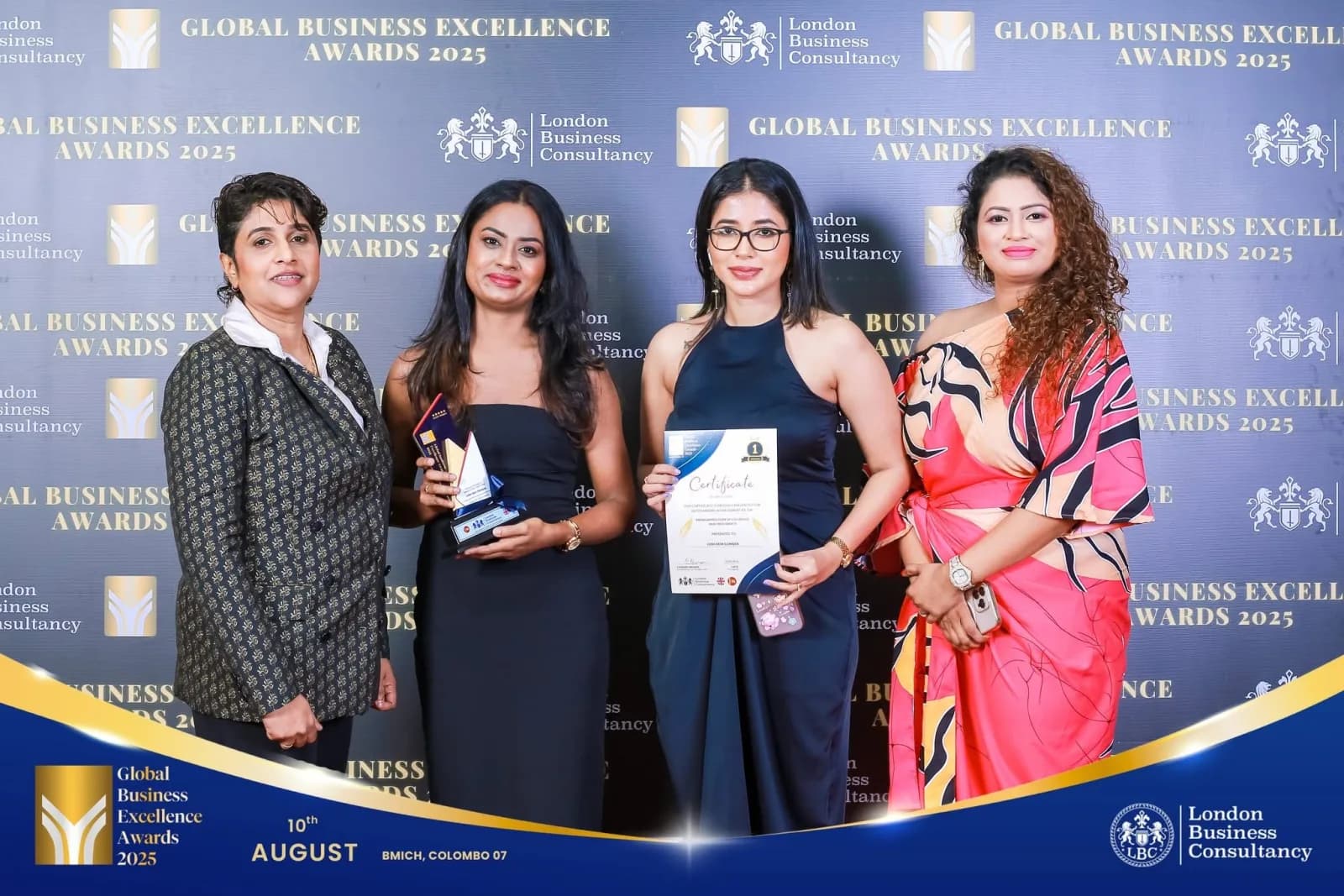 Award recipients at a branded event photography wall
